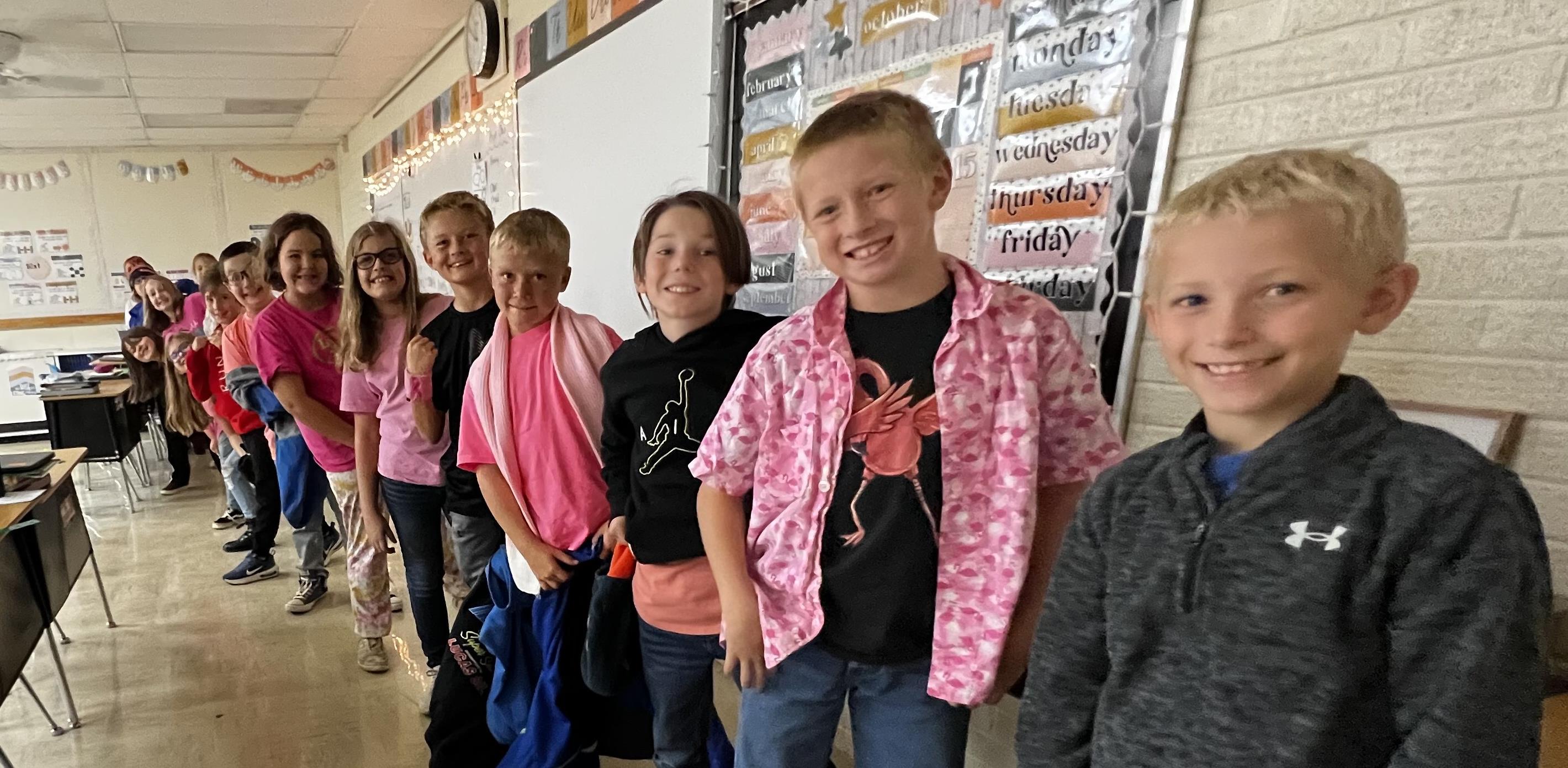 4th grade students dressed in pink for pink day.