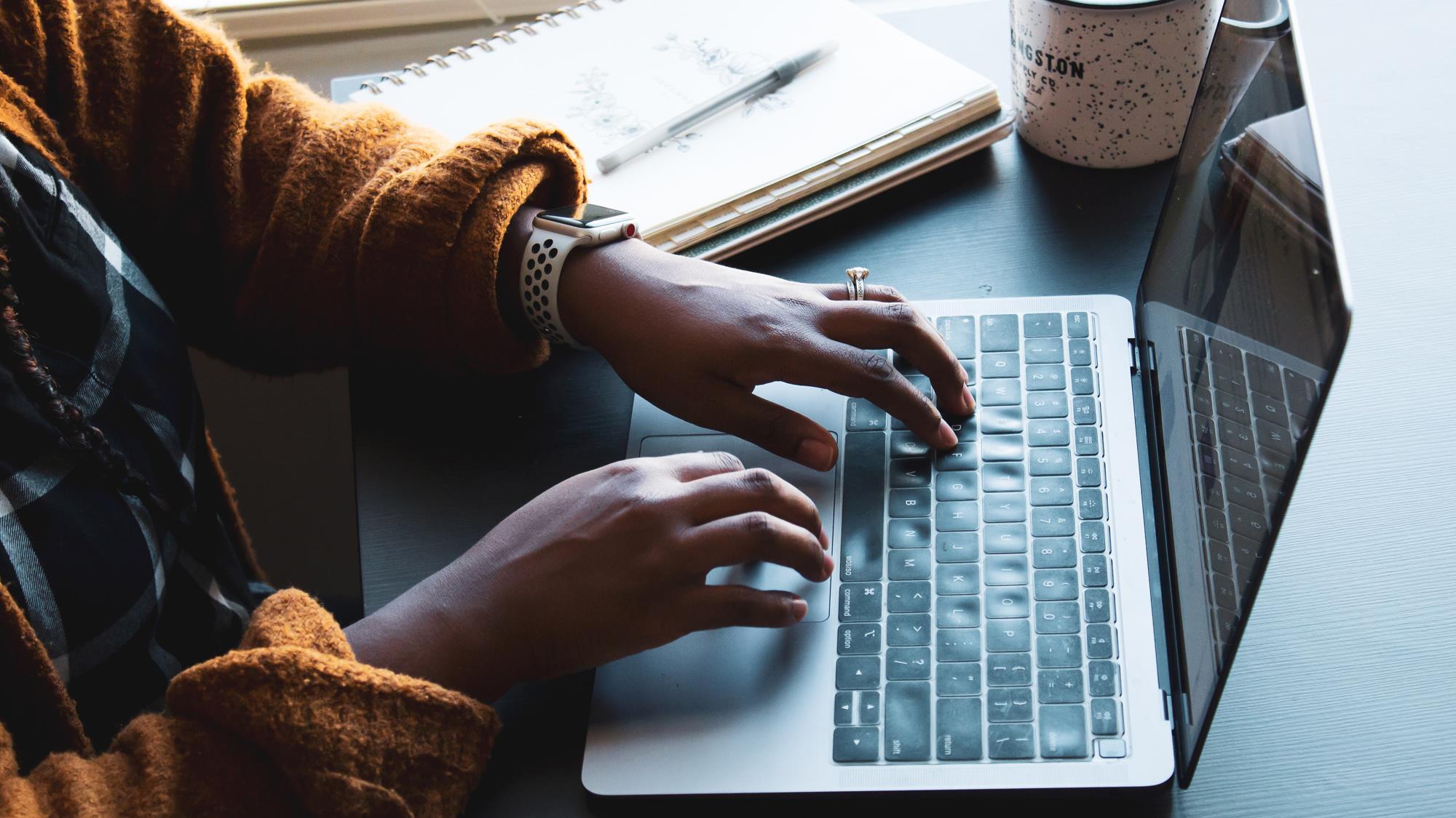 Photo of person using laptop Photo of person using laptop