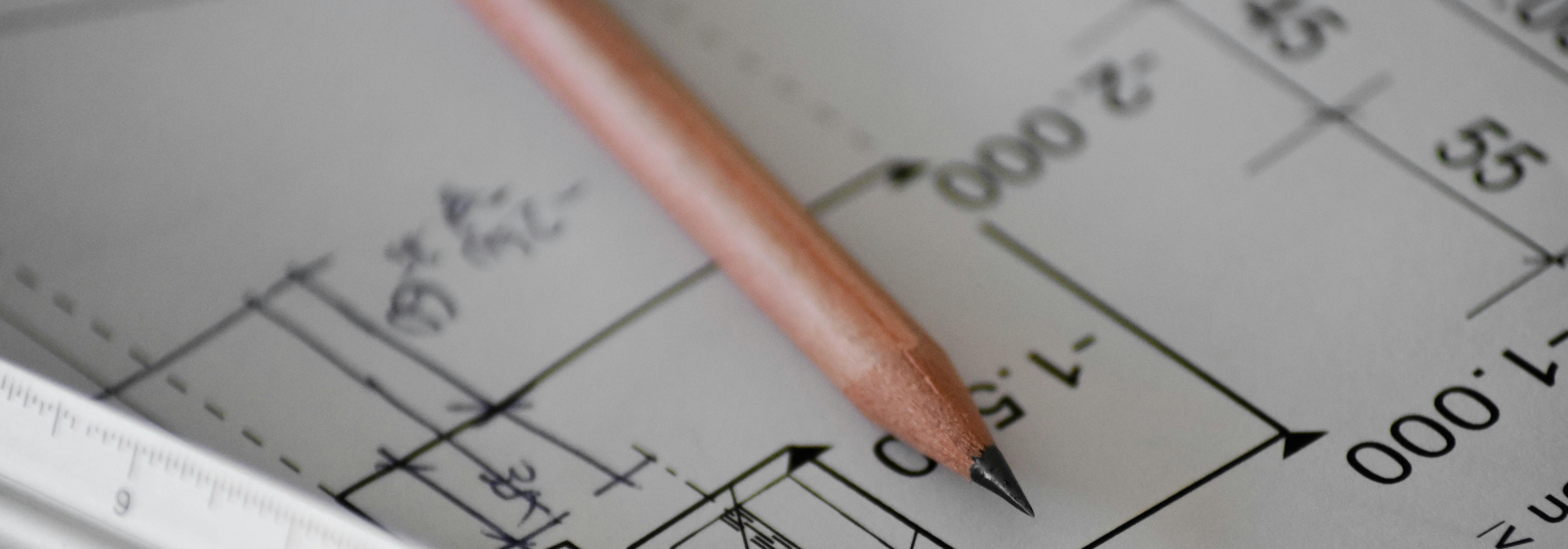 A pencil sits on a blueprint document A pencil sits on a blueprint document