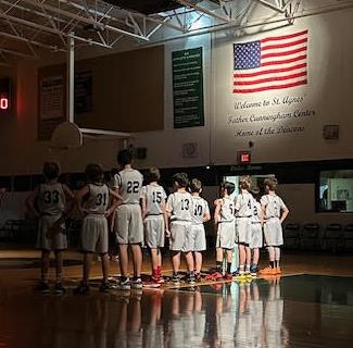 boys in basketball uniforms standing for the star spangled banner  boys in basketball uniforms standing for the star spangled banner