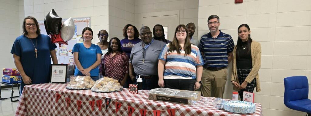 Ben Hill Site Staff and Community Partners serving food to students