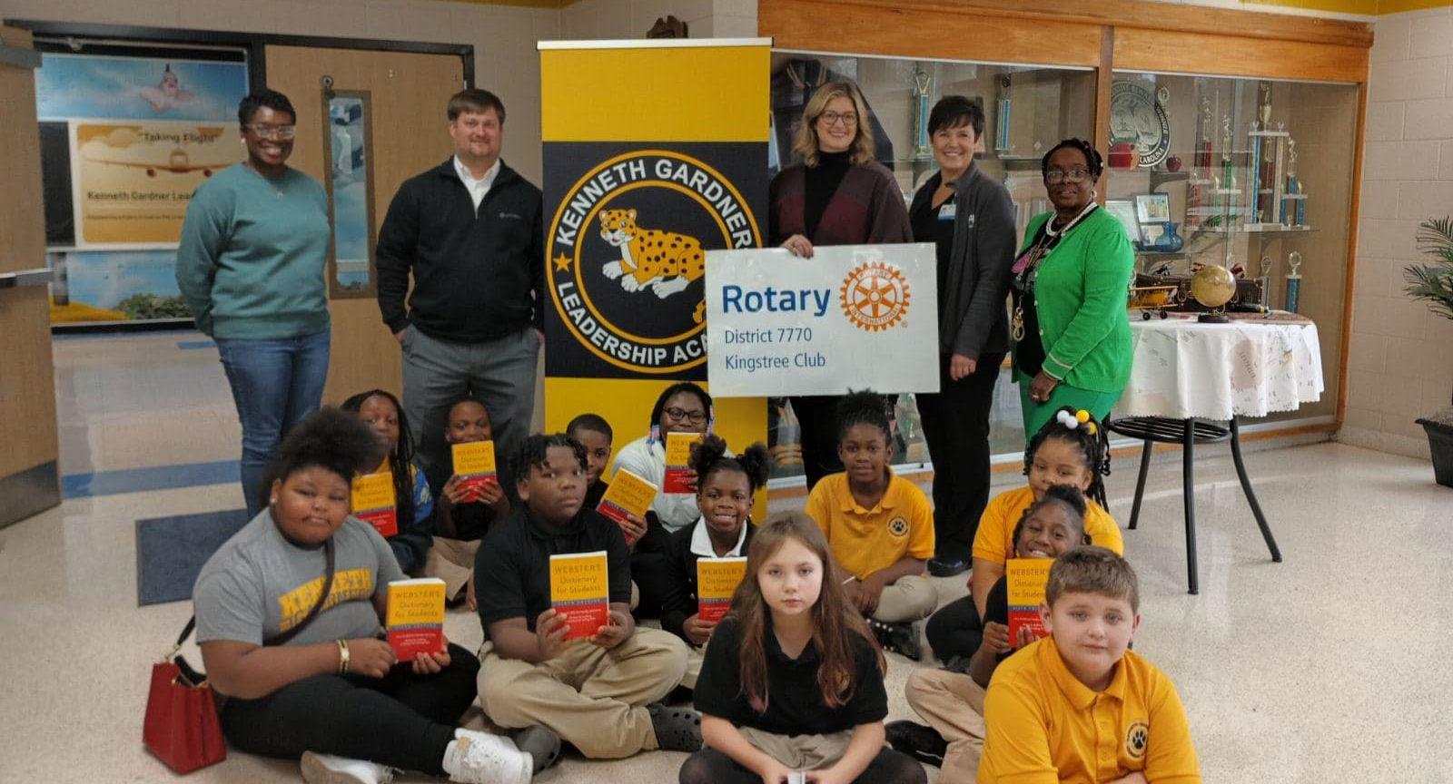 students pictured with principal and teachers along with rotary club members