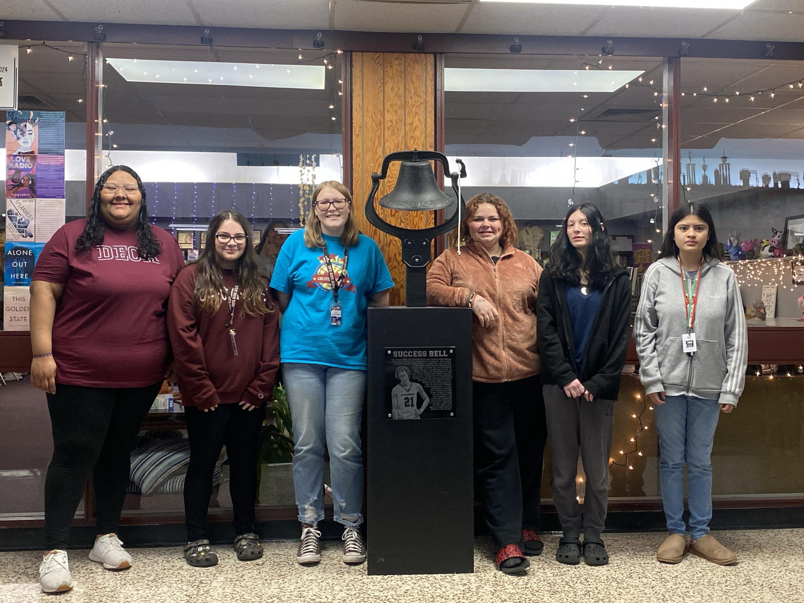 A H S students pose for the camera and success bell in the A H S student center