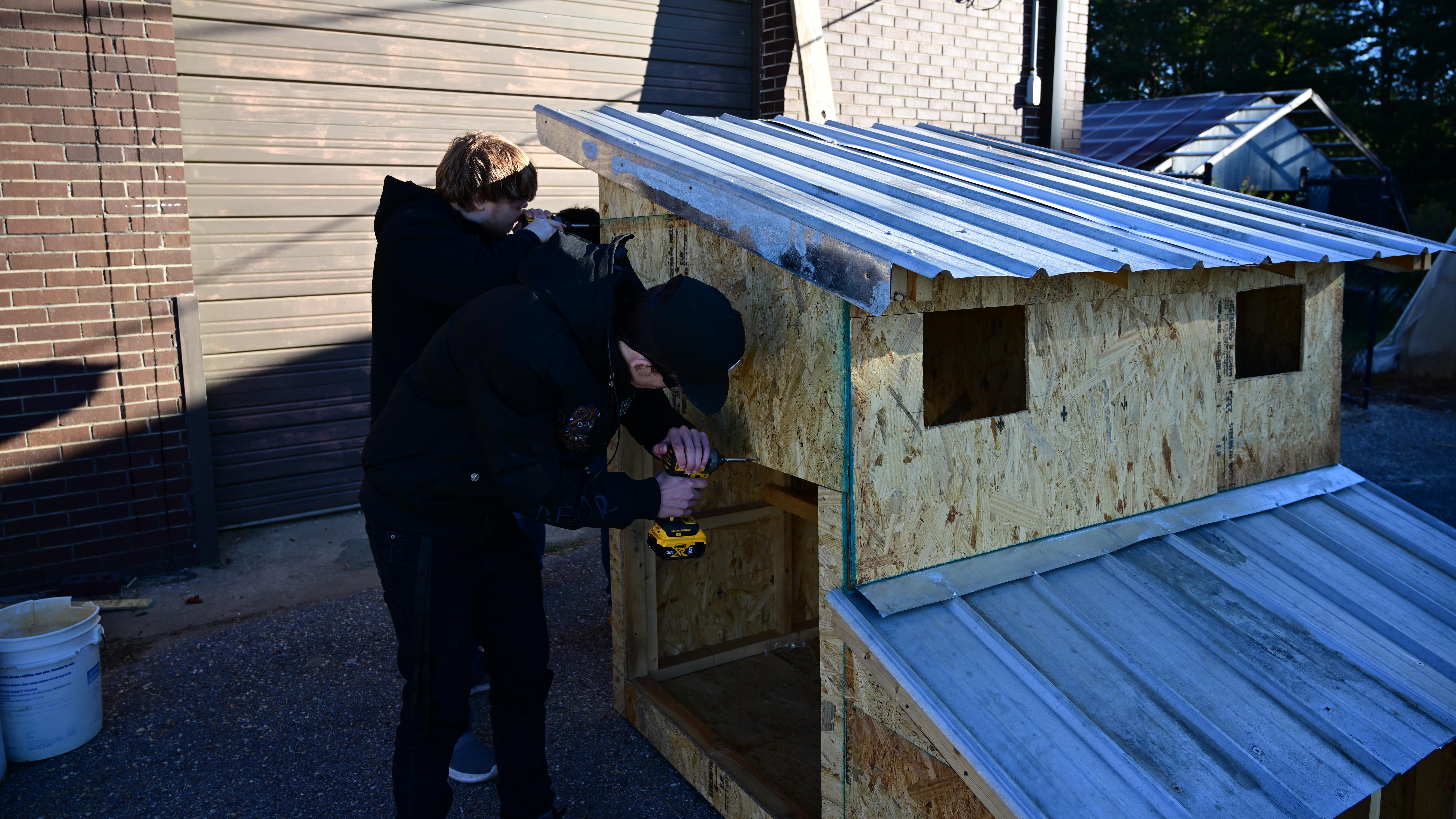 Students building chicken coop