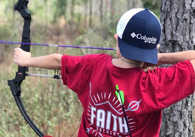 student with bow and arrow student with bow and arrow