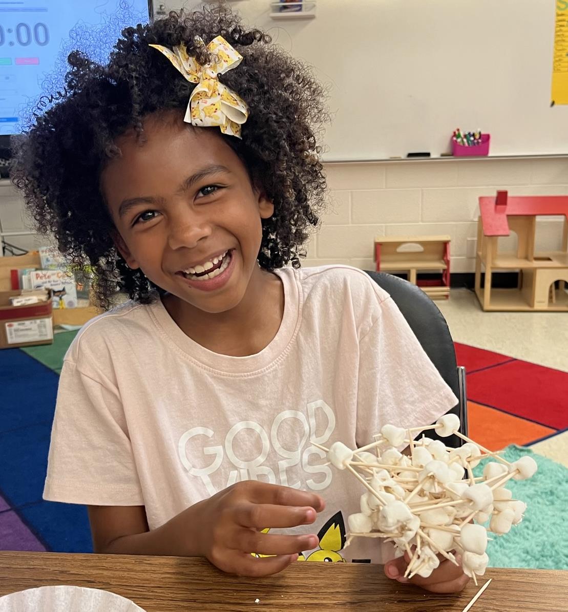 Girl building marshallow and toothpick structure