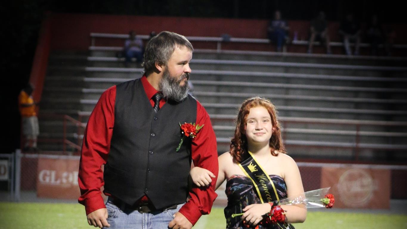 Homecoming attendant in a black dress with escort