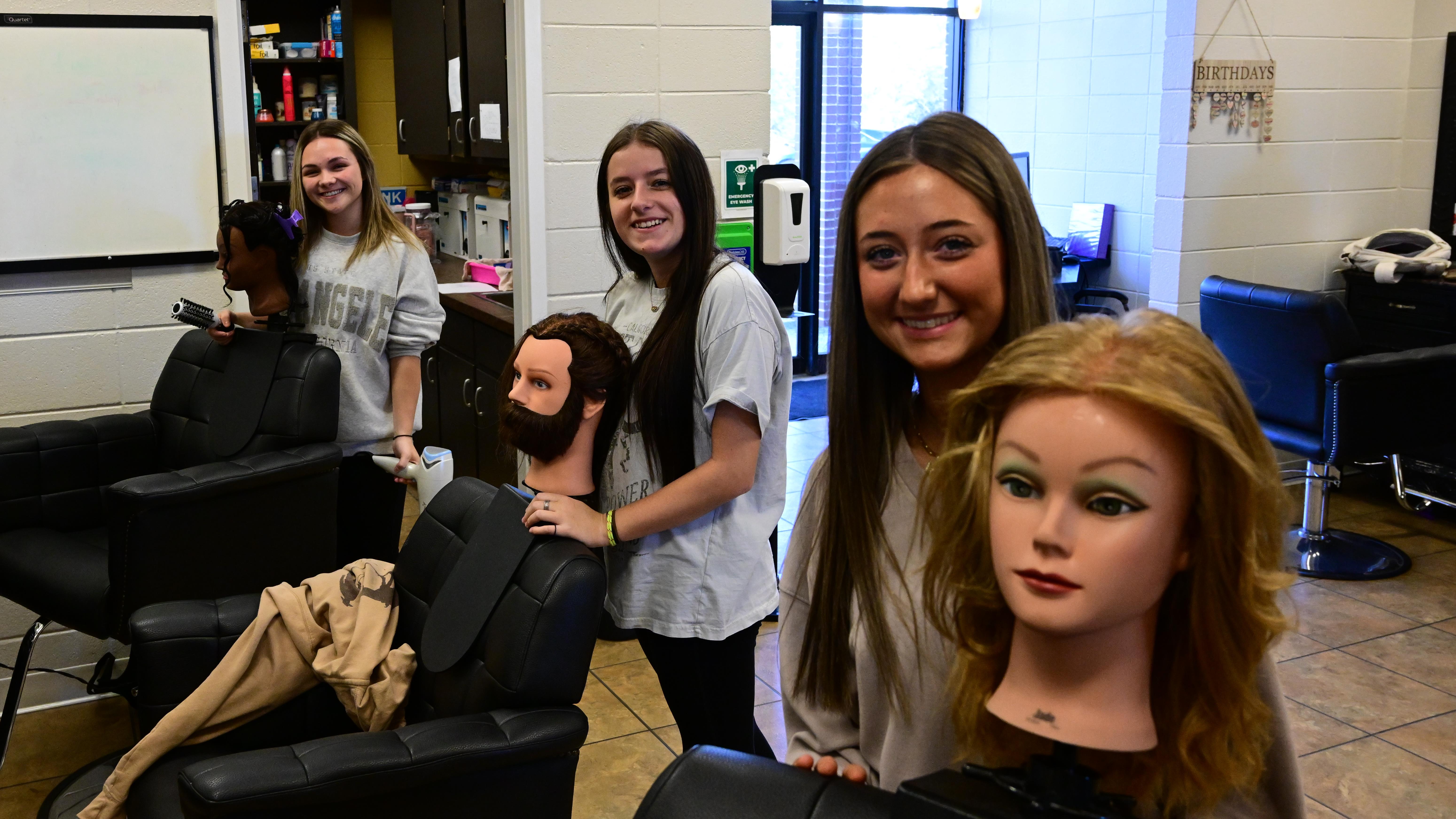 Cosmetology students cutting hair