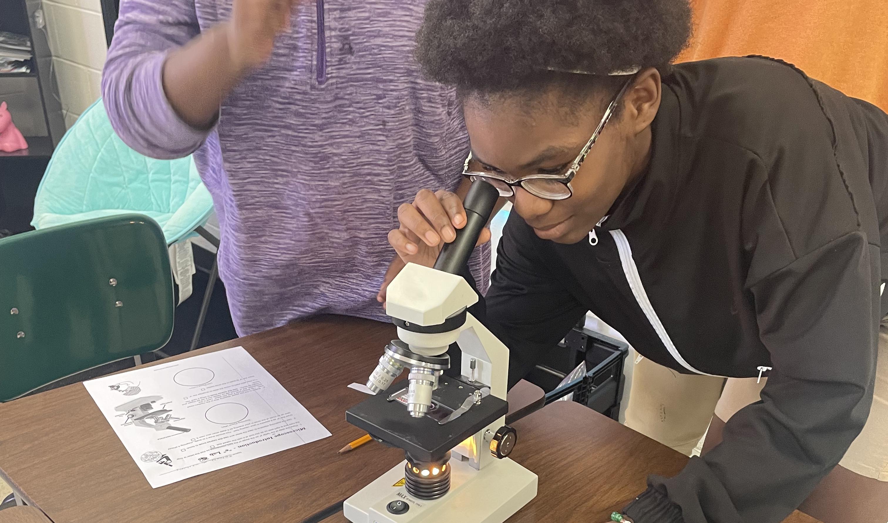 Student with Microscope 