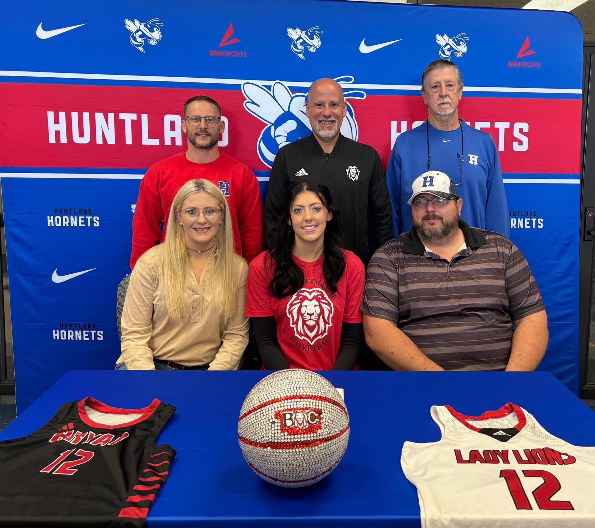 Pictured celebrating this exciting commitment are Riley with her parents, Logan Newman and Andy Maxwell, alongside her supportive coaches: Coach Matt Prince, Coach Bollant of the Bryan Lions, and Coach Bob Robertson.
