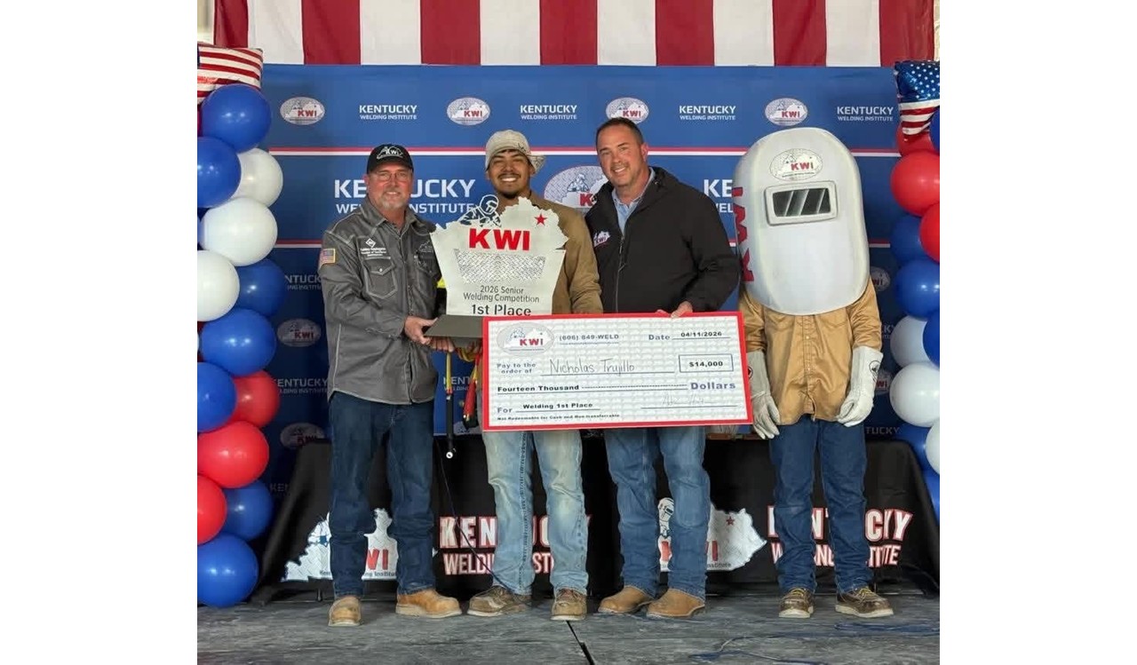 Photo at the Kentucky Welding Institute National Contest, Balloons red white and blue, Kentucky Welding Institute Backdrop, with Nick Trujillo being presented his 1st place award and $14,000 scholarship.